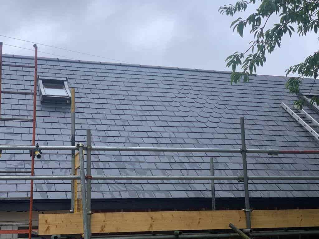 This is a photo of a tiles slate roof being repaired by Leicester Roofing Services