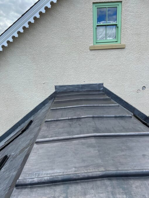 This is a photo of an extension on a house with a newly laid lead roof by Leicester Roofing Services