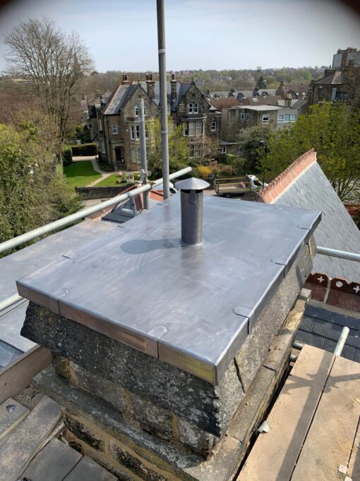 This is a photo of a chimney that has a new lead covered top. This was installed by Leicester Roofing Services