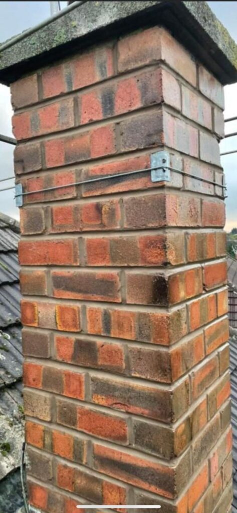 This is a photo of a chimney stack that has been repointed. The work was carried out by Leicester roofing services