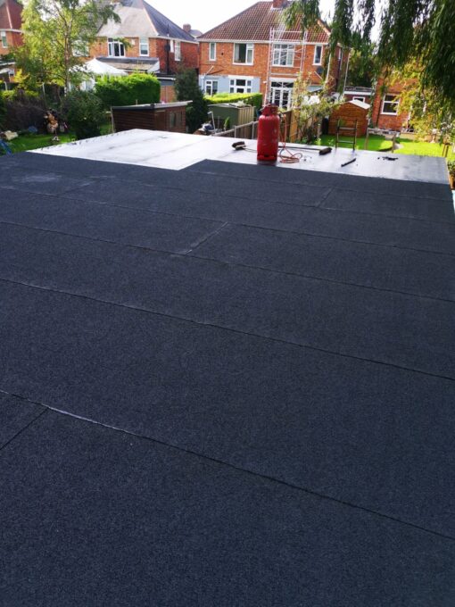 This is a photo of roofing felt being laid on a flat roof in Leicester. This work is being done by Leicester Roofing Services